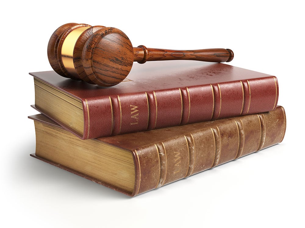 Law books and gavel isolated on white background.